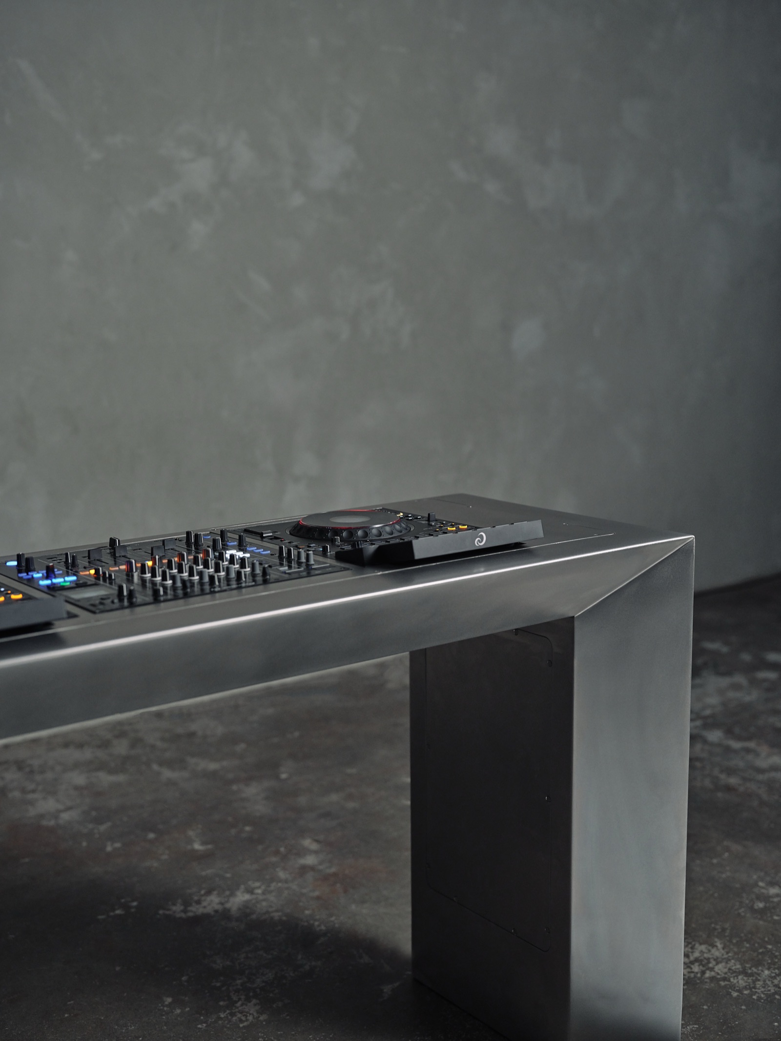 Close-up of the stainless steel DJ table with the decks on top