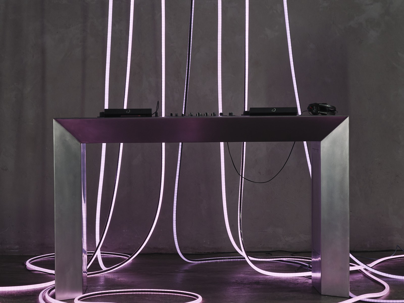 Close-up of the white rope lighting curling across the dancefloor under the stainless table