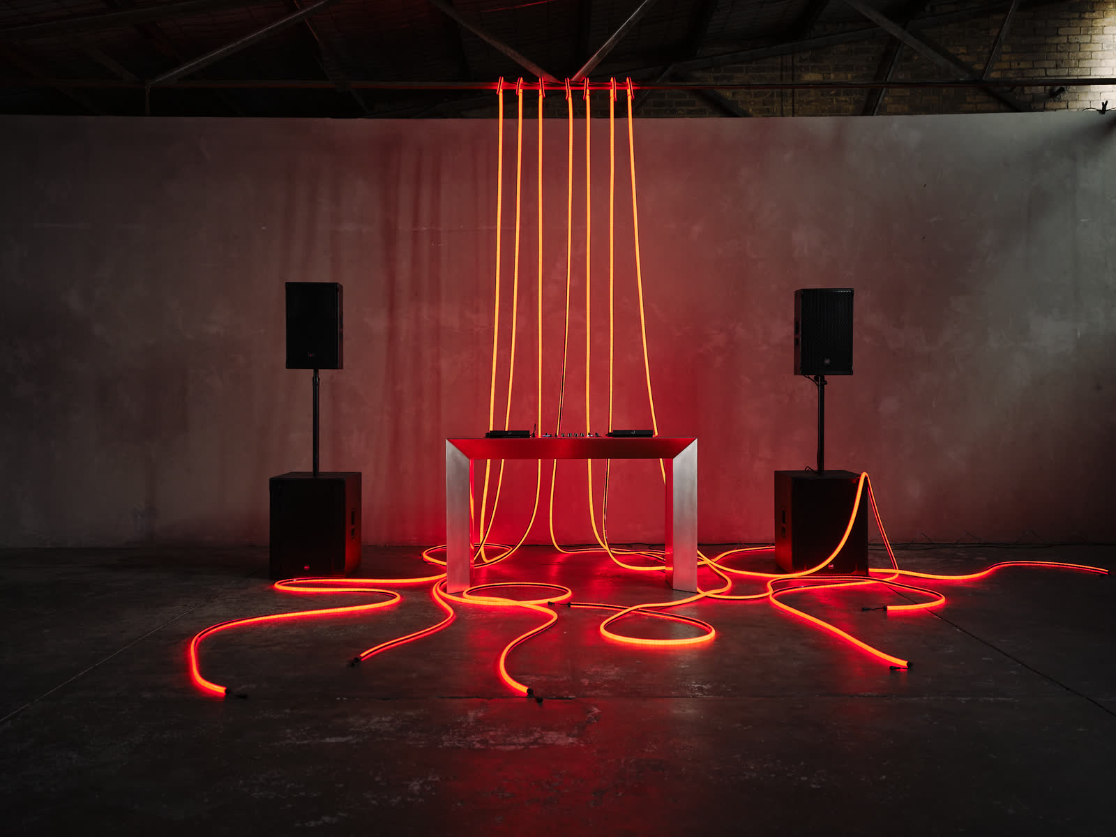 Stainless steel DJ table with red tube lighting, the full setup at a Melbourne wedding reception