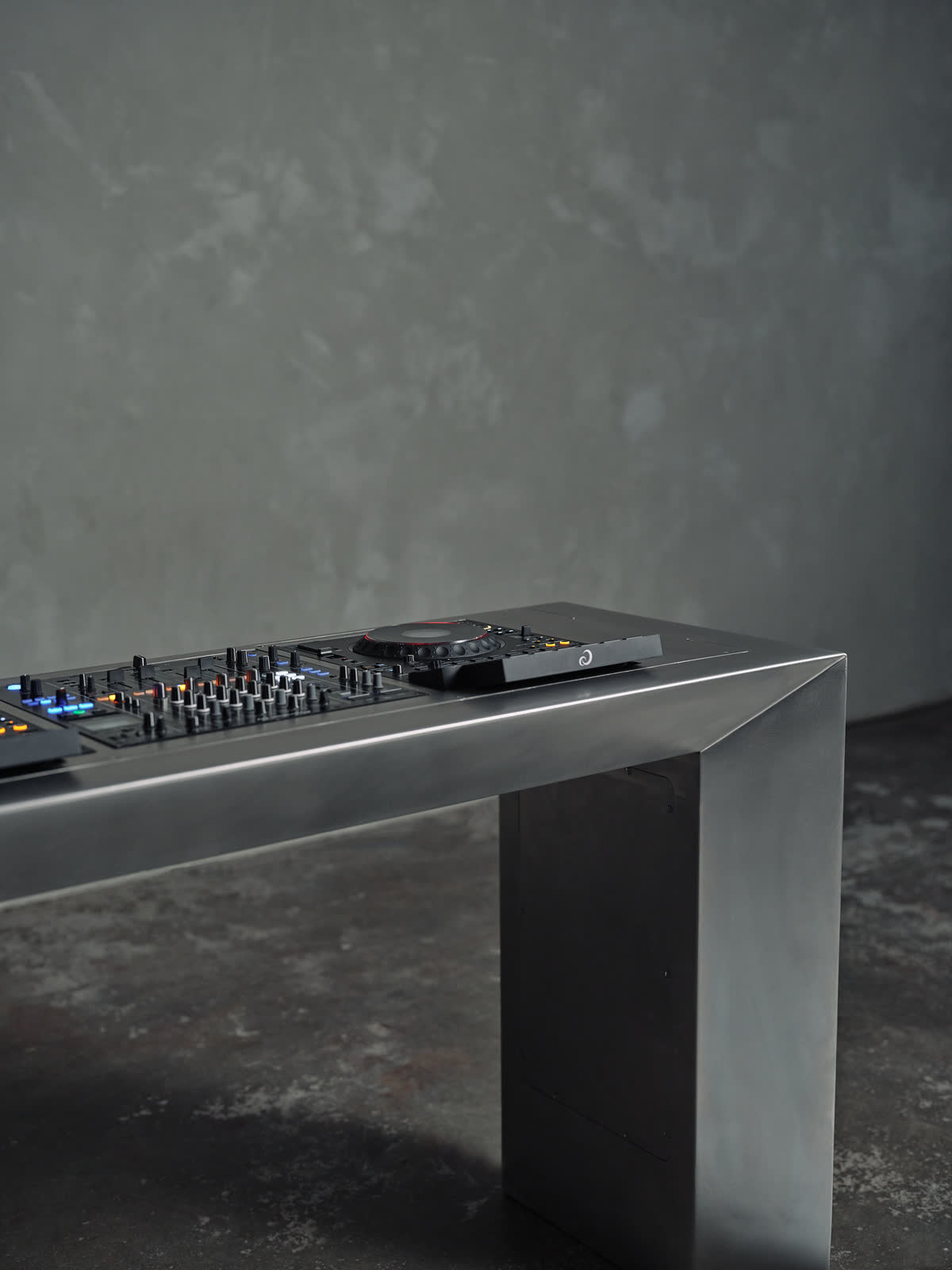 DJ decks on the stainless steel table, seen from the side