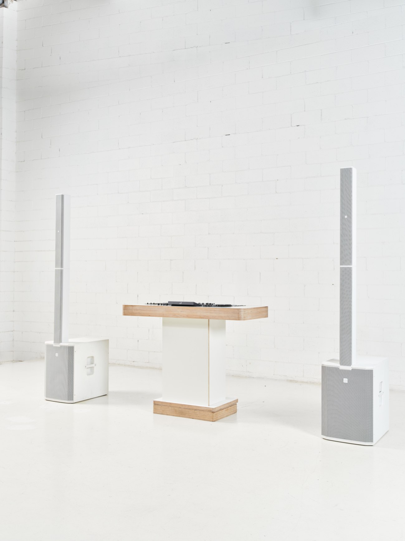 Josh's custom white DJ booth and speaker setup at a Melbourne wedding venue